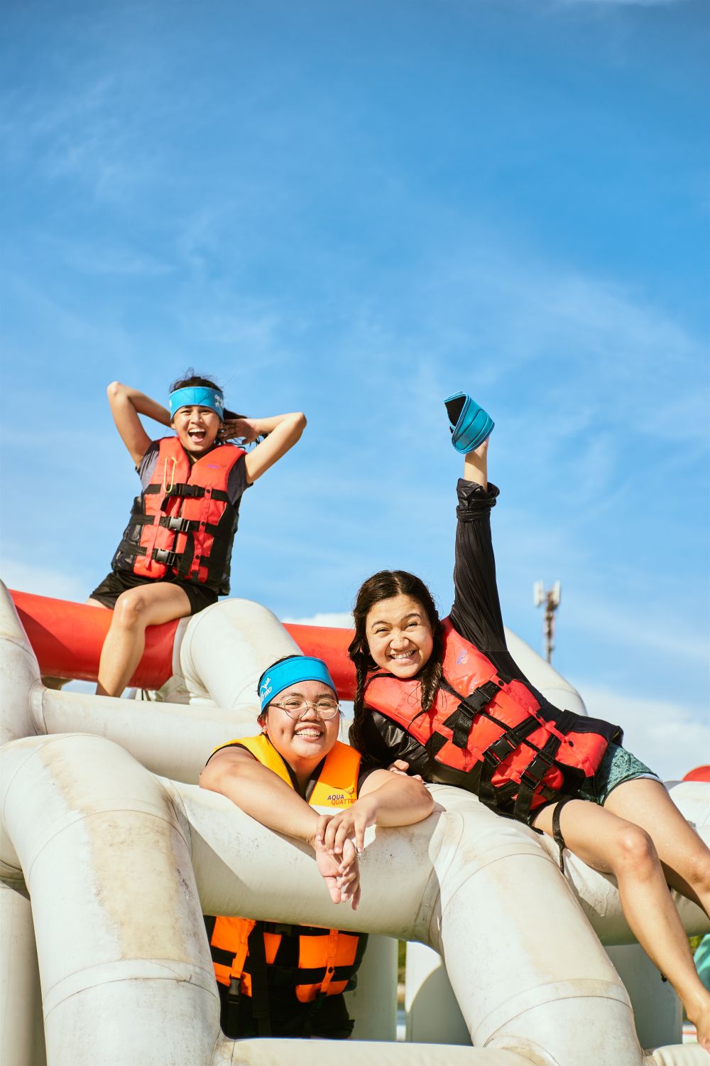 8 Hard Truths Washington Families Should Know Before Wild Waves Closes for Good 2 Three people enjoying a sunny day at a water park, wearing life vests and smiling.