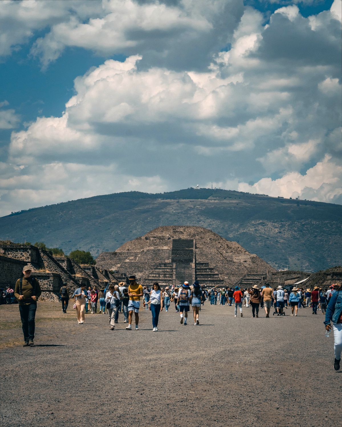 Visitors exploring Teotihuacan's Pyramid of the Moon, capturing Mexican culture and history.
