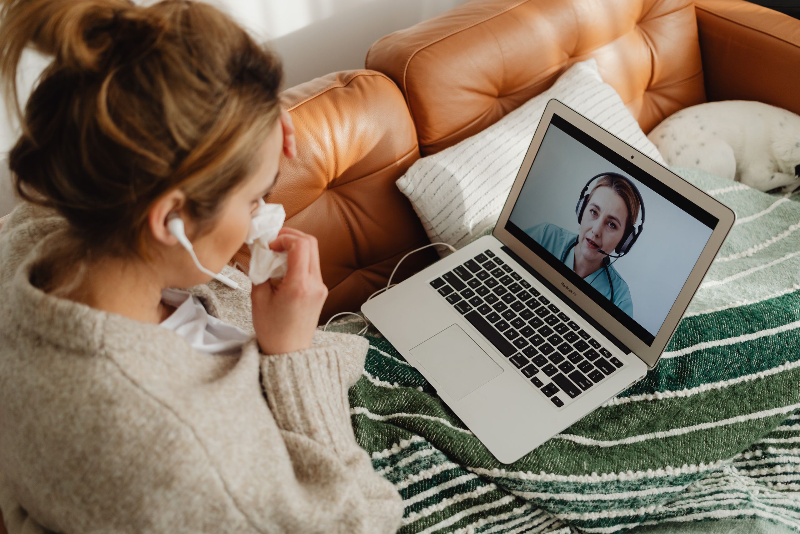 Woman Refuses to Help Coworker After Being Abandoned Sick on a Holiday 1 Woman having an online medical consultation on a laptop from her cozy sofa.