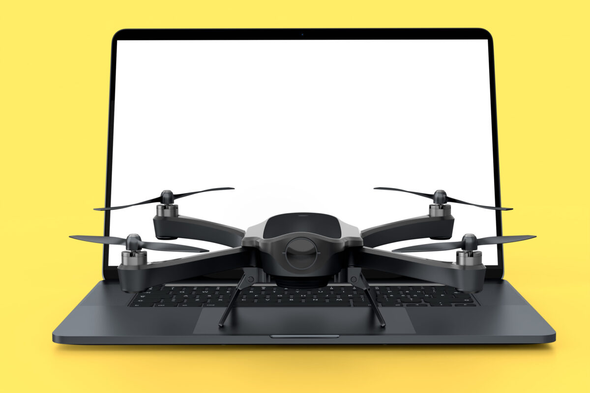 Top view of designer workspace and photography gear like laptop and drone on yellow background. 3d render of accessories for drawing, sketching and photography tools