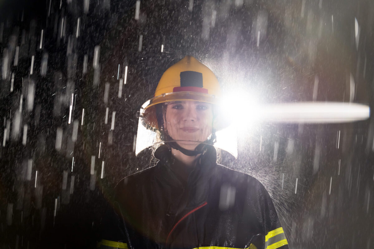 Portrait of a female firefighter standing and walking brave and optimistic.