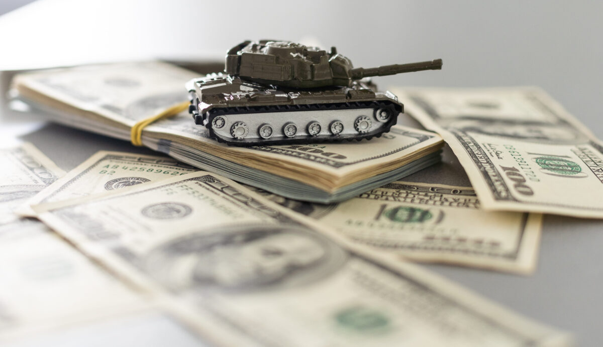 Chuck Schumer’s Senate Floor Moment Goes Viral as the Iran Debate Gets Drowned Out 2 Tank on dollar bills. The concept of war costs, military spending.