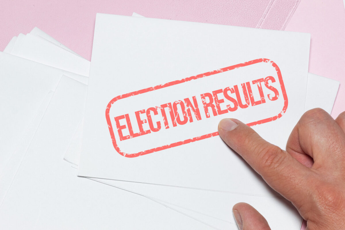 aEURoeElection ResultsaEUR? stamp applied to a stack of ballots
