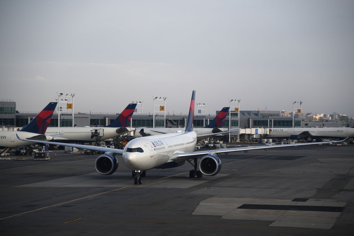 A commercial airplane on the runway at a New York airport during the day.