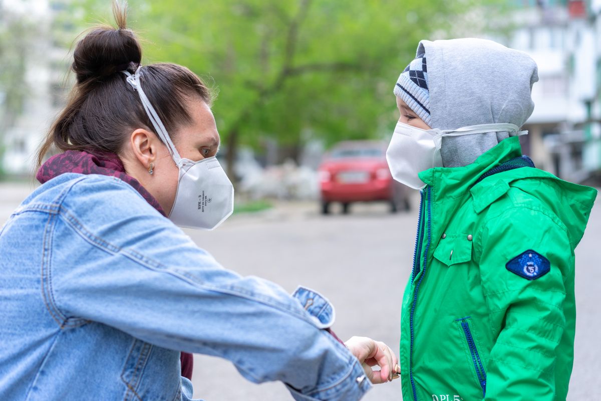 835 Canadian Wildfires Darken U.S. Skies as Hazardous Smoke Reaches Millions 2 A woman and child wearing face masks for protection outdoors.
