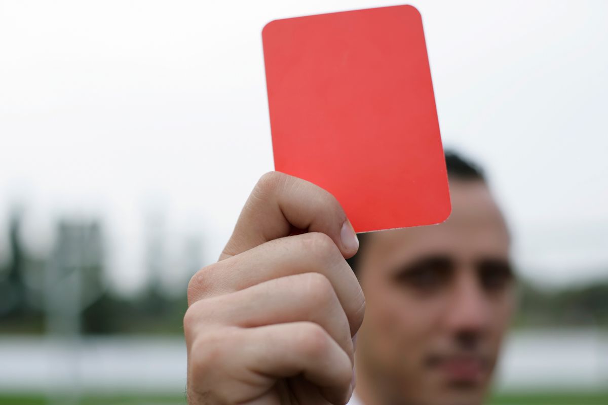 Argentina World Cup Controversy Deepens as Fans Question Whether Football’s Biggest Stage Is Truly Fair 1 Close-up of a referee holding a red card, signaling a penalty in a soccer match.