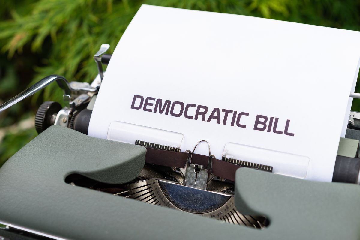 Trump’s Freedom 250 Celebration Faces New $10 Million Taxpayer Question as Congress Demands Answers 2 Close-up of a vintage typewriter printing a democratic bill, symbolizing government and legislative concepts.