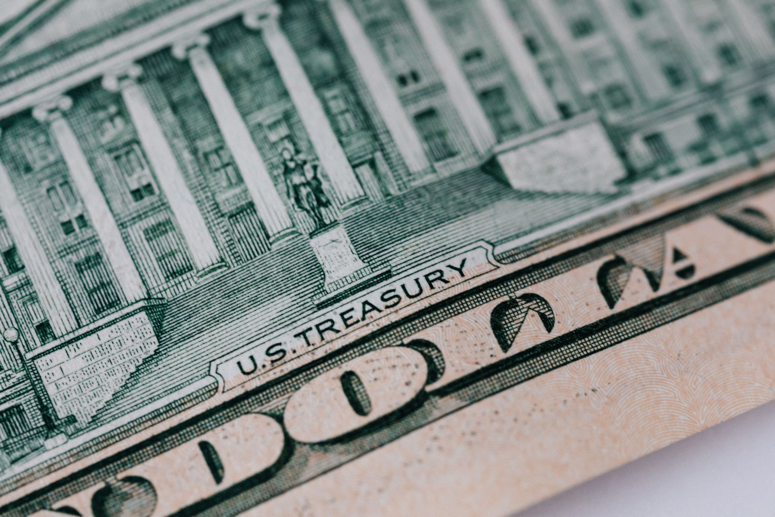 How Did Nearly $99 Million in Federal Payments Get Linked to Dead Americans? 1 From above ten dollar banknote with inscription and United States treasury building placed on table