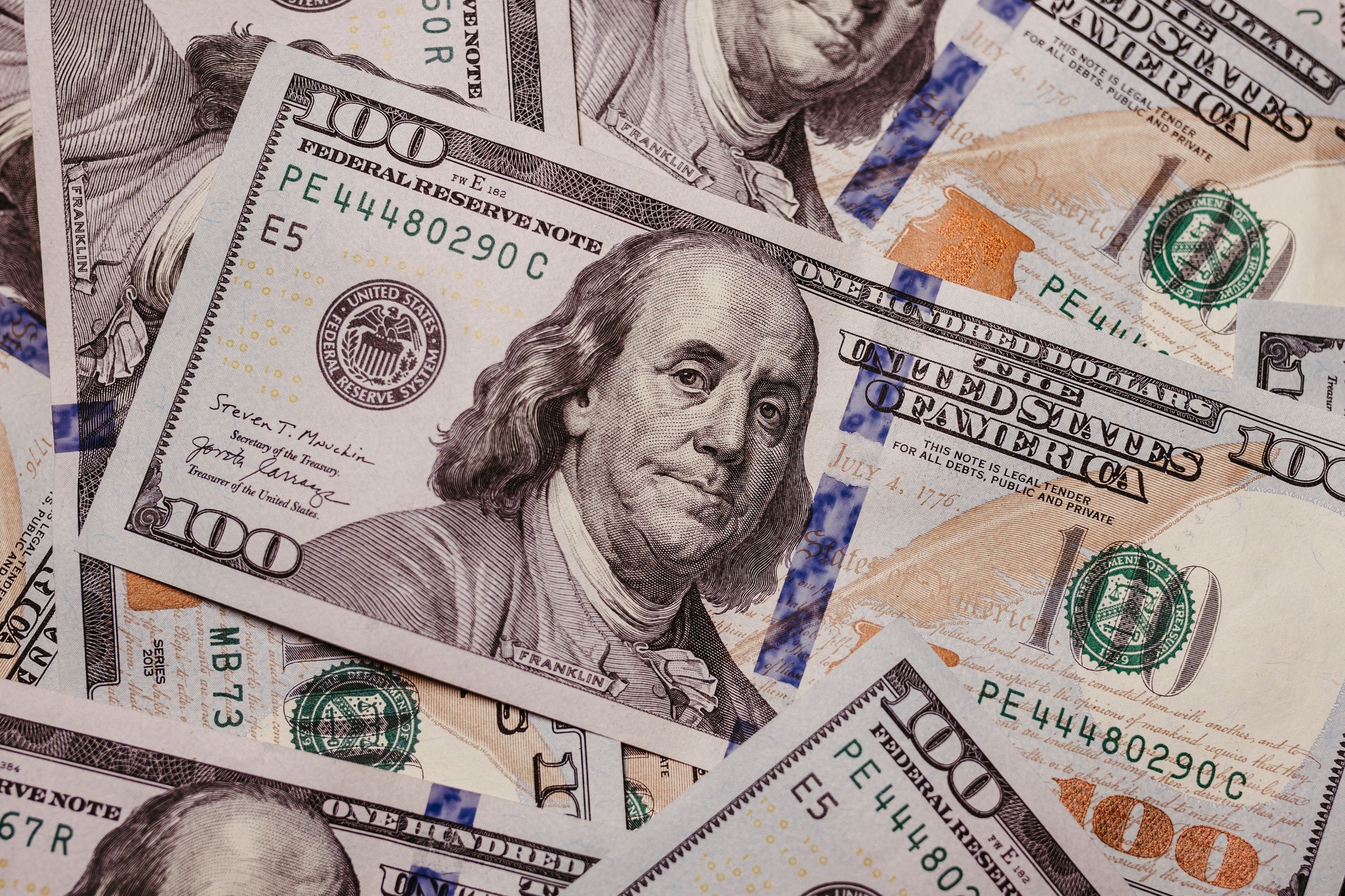 High-resolution image displaying a variety of US dollar banknotes in focus, symbolizing finance.