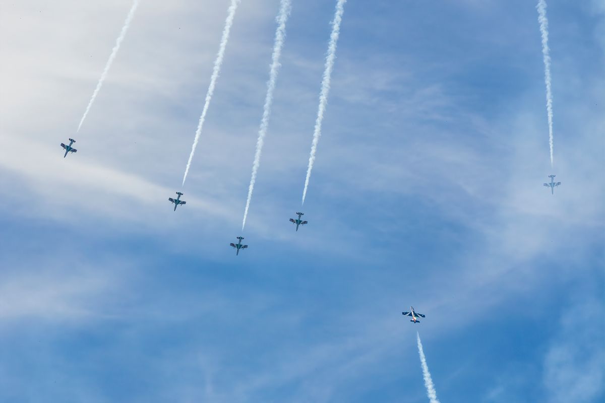 The Fighter Jet Race Is Changing as New Technology Redefines the Future of War 2 Impressive formation of military fighter jets performing an aerial display with trail smoke under a blue sky.