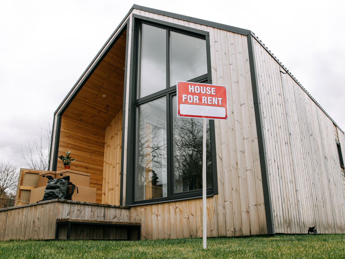 Report Says Rising Costs Are Challenging America’s Long-Standing Homeownership Wealth Formula 1 Low-angle view of a modern wooden house with a 'House for Rent' sign, showcasing contemporary architecture.