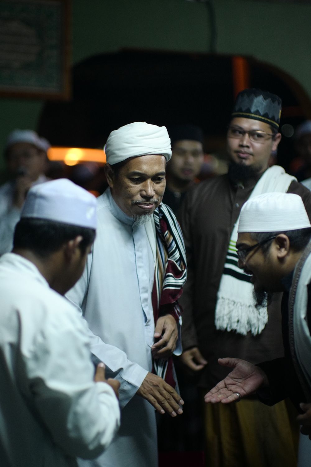 Men in traditional attire at a religious gathering in Muar, Johor, Malaysia.