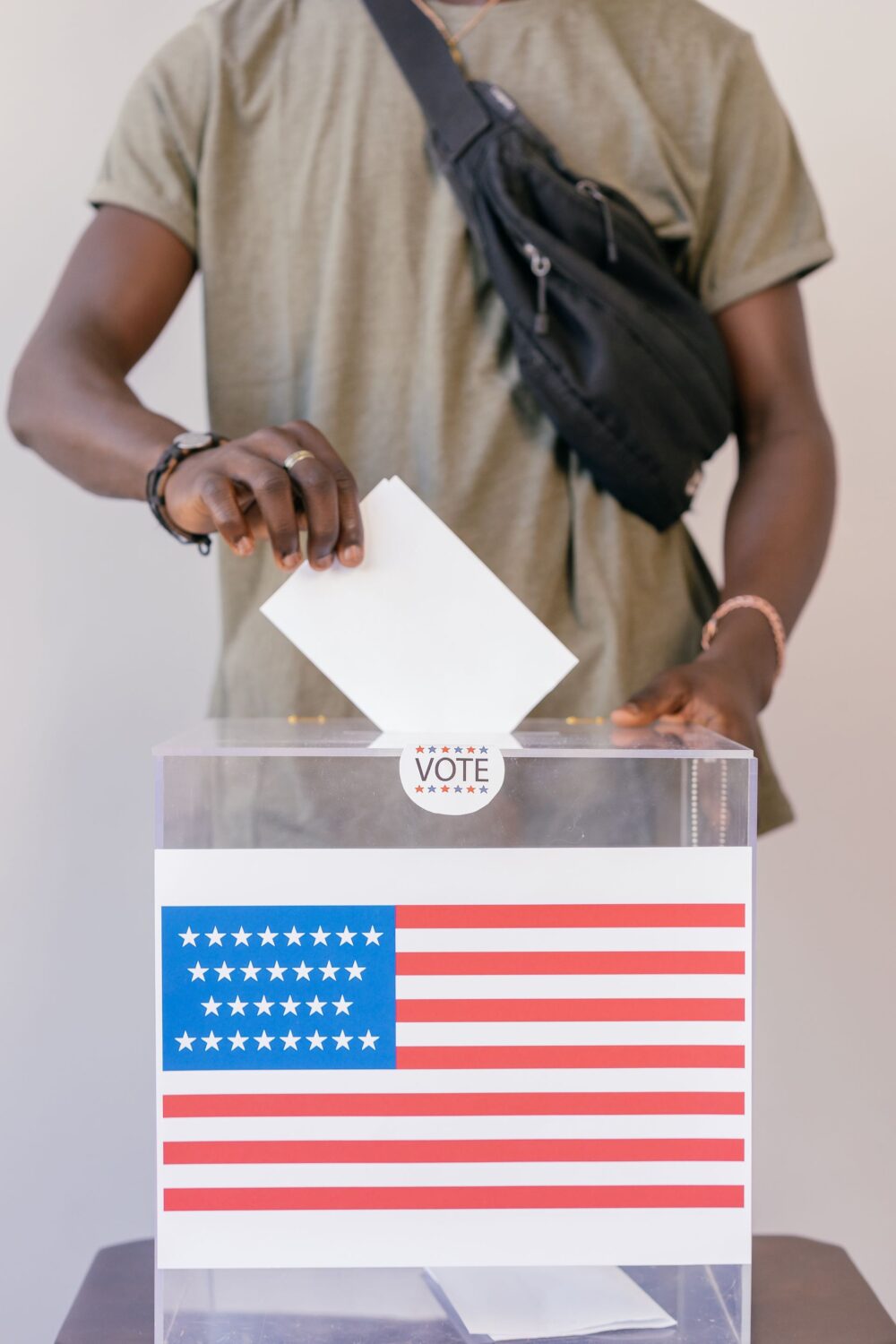 More Than 1.5 Million Children Lost SNAP Benefits as Food Stamp Cuts Become a 2026 Midterm Test 3 man-putting-paper-on-ballot-box