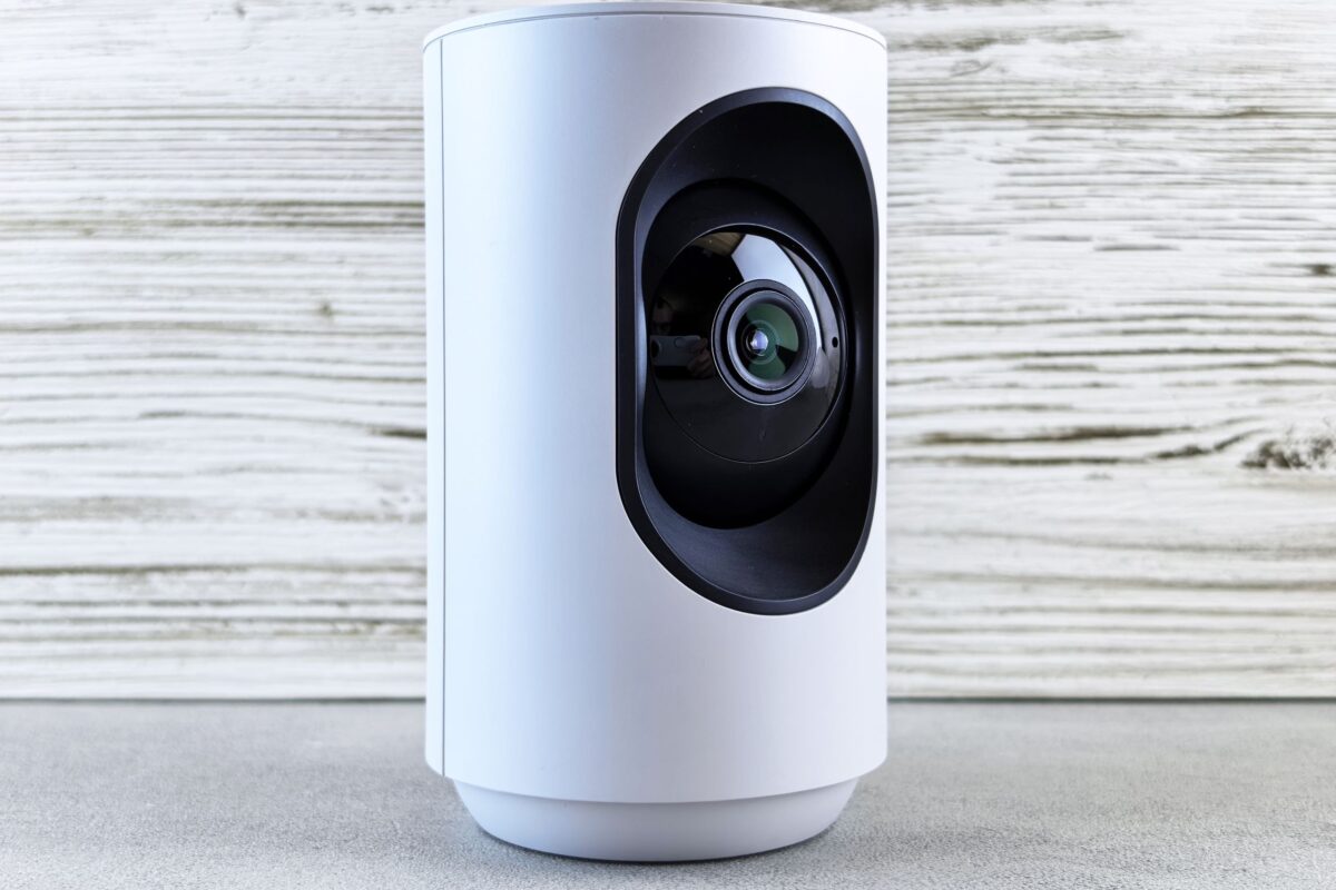white-indoor-security-camera-on-wooden-surface