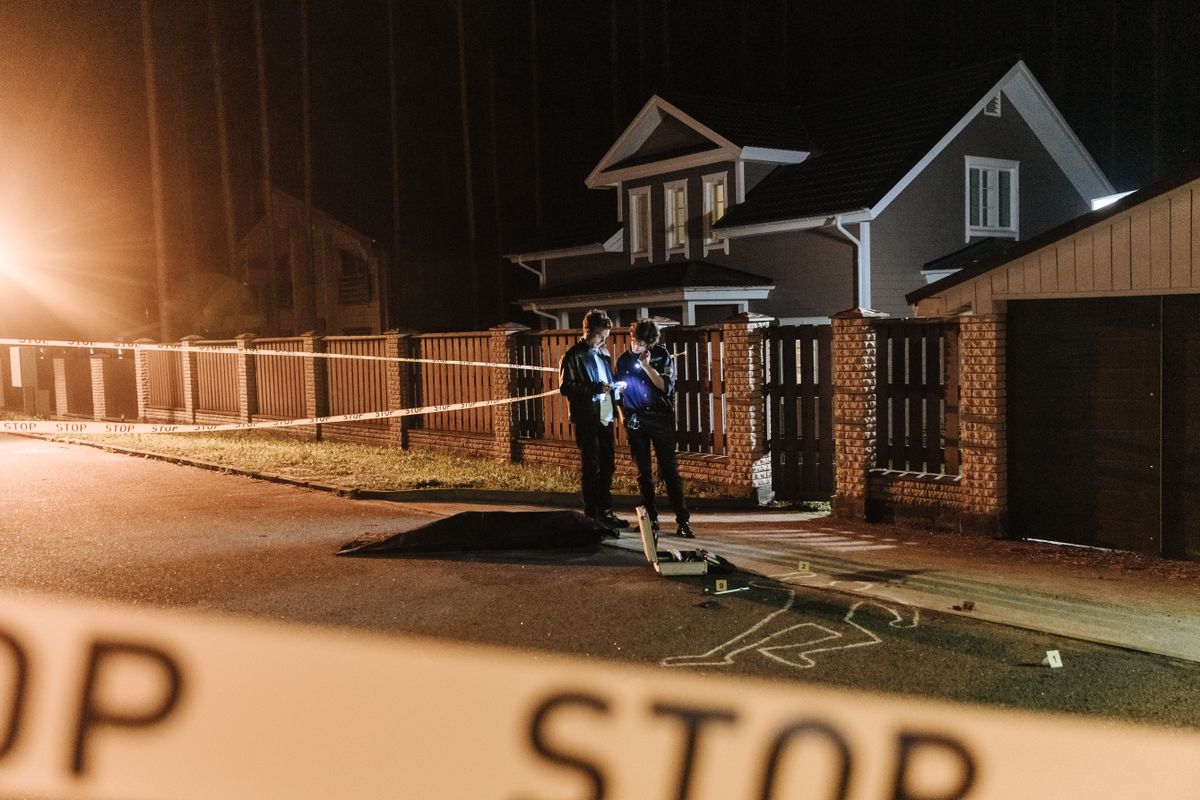 Nancy Guthrie Ransom Notes May Hold the Key: How Words, Bitcoin and Hidden Clues Could Expose Her Kidnapper 5 Police officers investigating a nighttime crime scene outside a residential house with barrier tape and evidence markers.