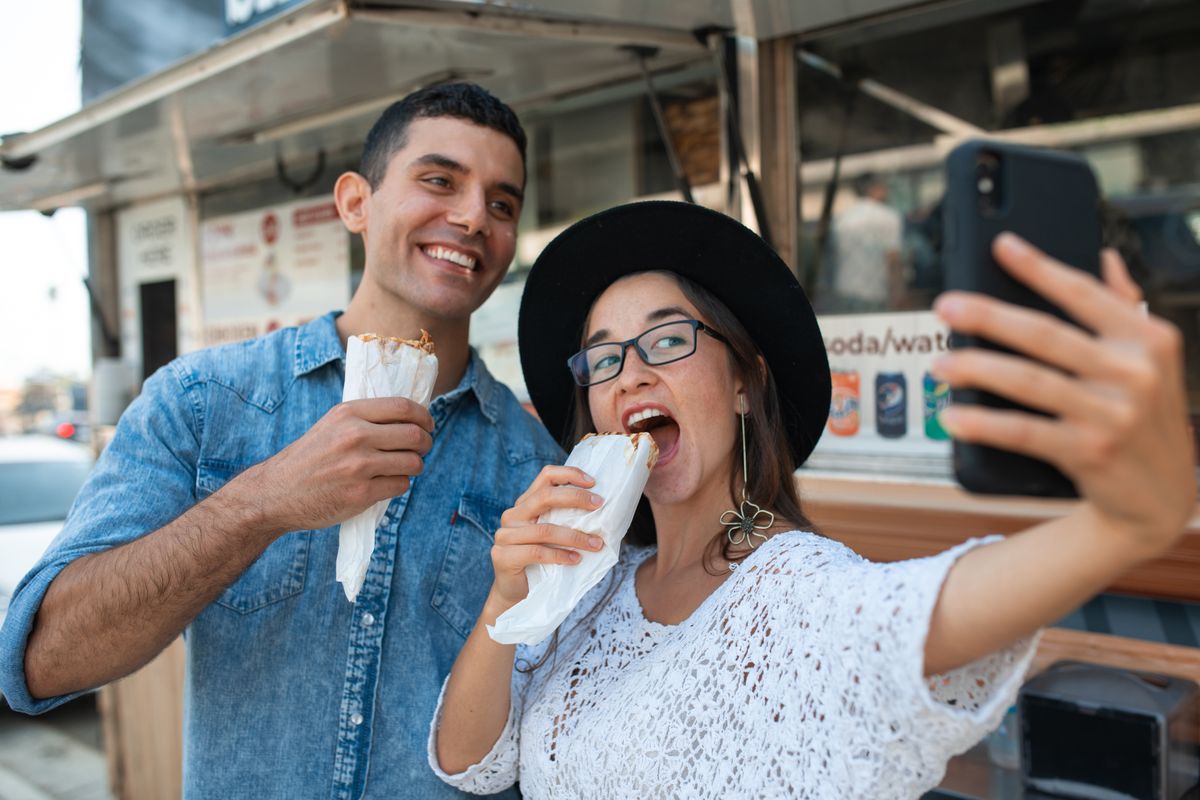 Chipotle Takes Its Biggest Gamble Yet as It Brings American Burritos Into Mexico’s Taco Kingdom 3 Two friends taking a selfie while enjoying delicious shawarma outdoors. Perfect foodie moment.