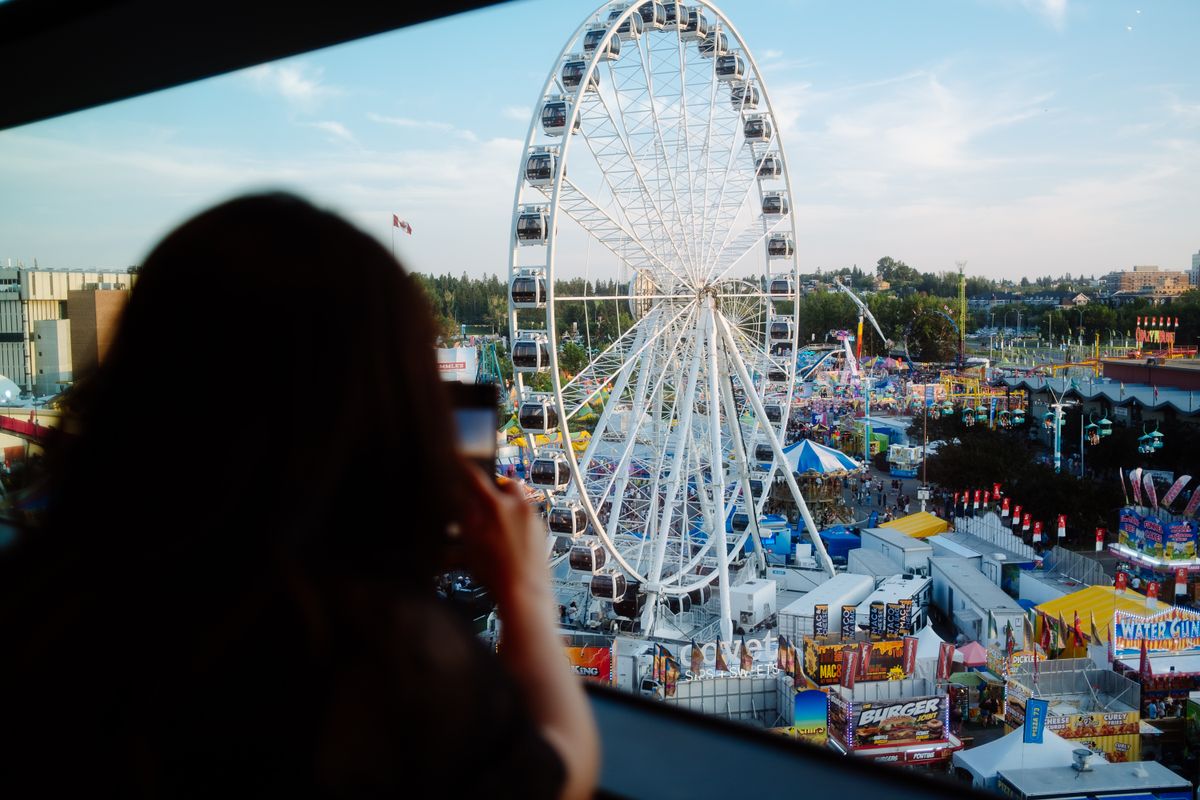 The Missing Trump Merchandise at the Great American State Fair and What It Really Signals 1 View of a Ferris wheel and fairground from above, with vibrant colors and lively atmosphere.