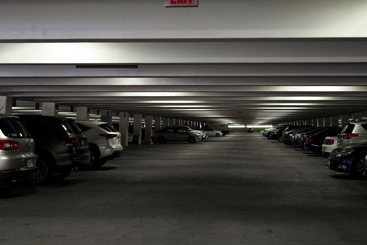 Wide view of a multi-storey parking garage with parked cars in Los Angeles, CA.