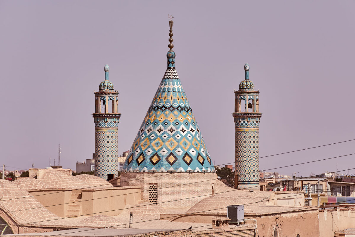 Kashan, Iran - April 26, 2017: Mausoleum of Sultan Amir Ahmad, The conical roof of the mosque and the towers of two minarets.