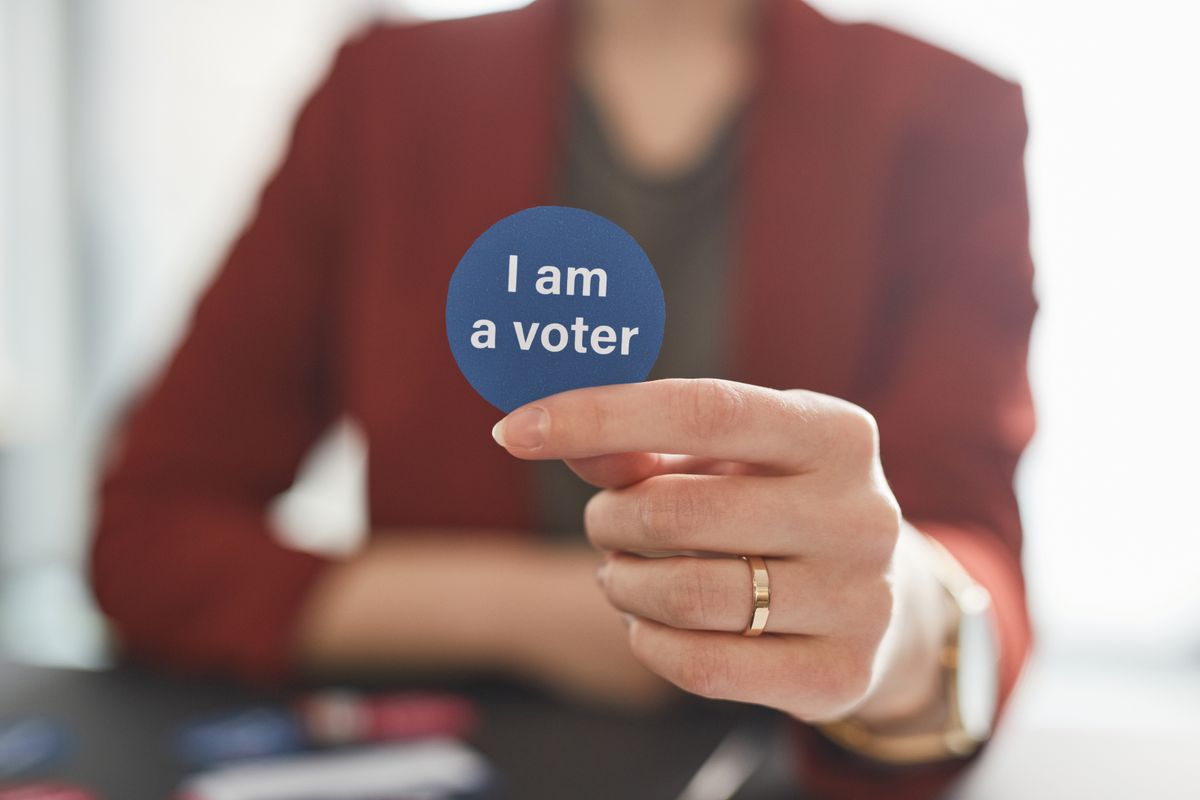 New Jersey Voter-Roll Failure Put 6,600 Noncitizens on the Rolls as Congress Demands Answers 1 A person holds a voter badge, symbolizing civic responsibility and participation.