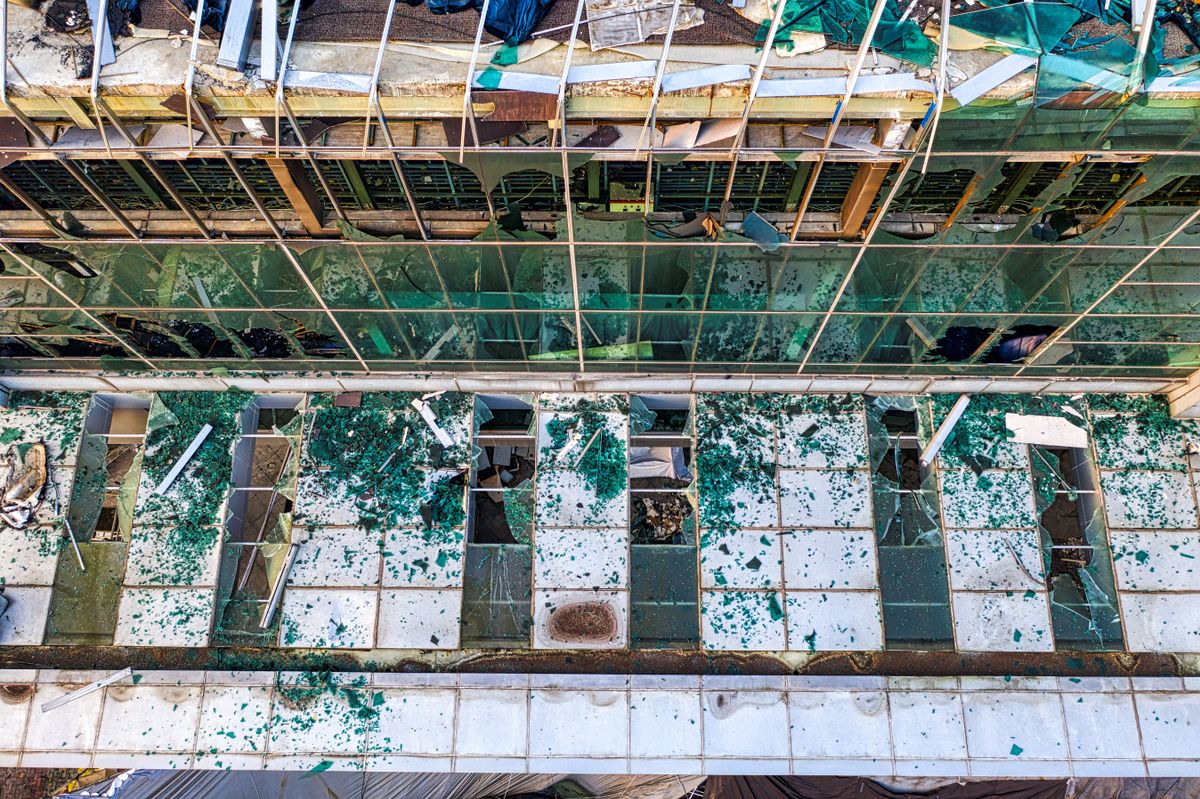 Aerial shot of a dilapidated building with broken glass and visible decay in Banten, Indonesia.