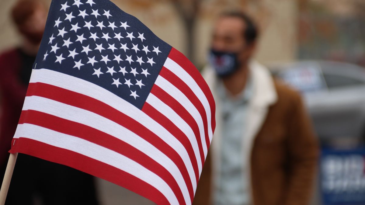 Max Miller’s Ohio Seat Becomes a Grim Test of Scandal, Power, and Voter Fatigue 2 American flag close-up with a person in a mask at an election event.