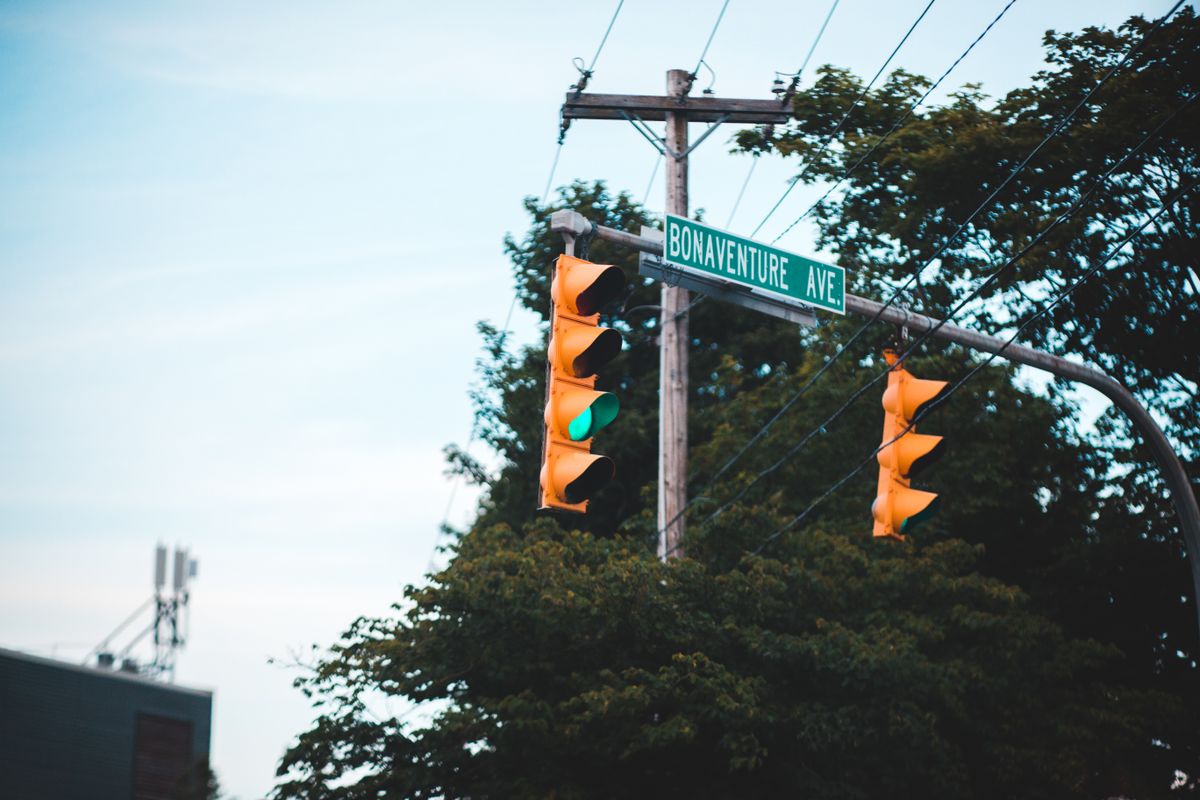 Stamford Plans $5 Million Glenbrook Intersection Overhaul to Improve Safety and Traffic Flow 1 Close-up of a green traffic light at an intersection with street signs on Bonaventure Ave.