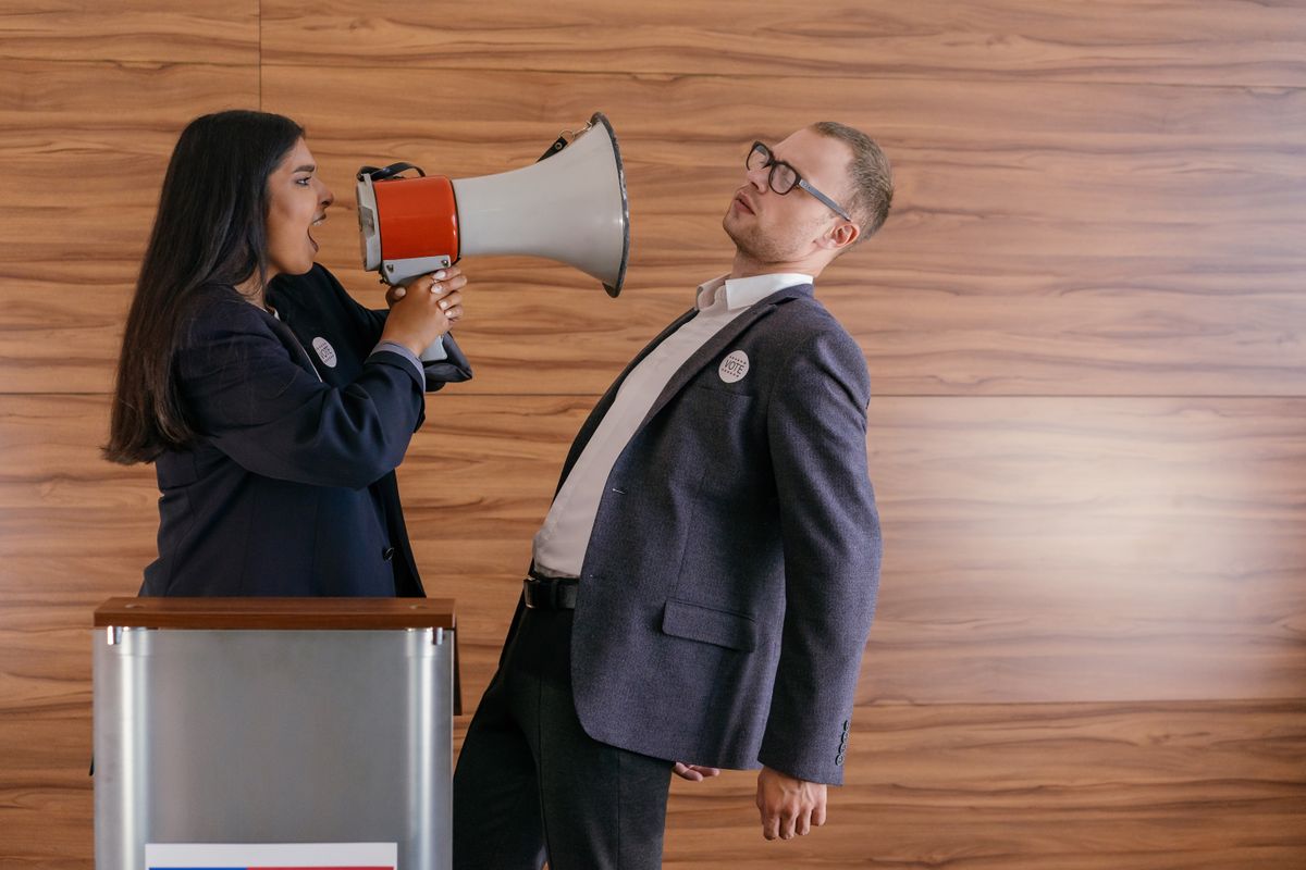 Trump Rejects Iran Link to Minnesota Water Cyberattacks and Blames State Leadership 3 Dynamic image of two politicians arguing; one shouts into a megaphone in a heated debate.