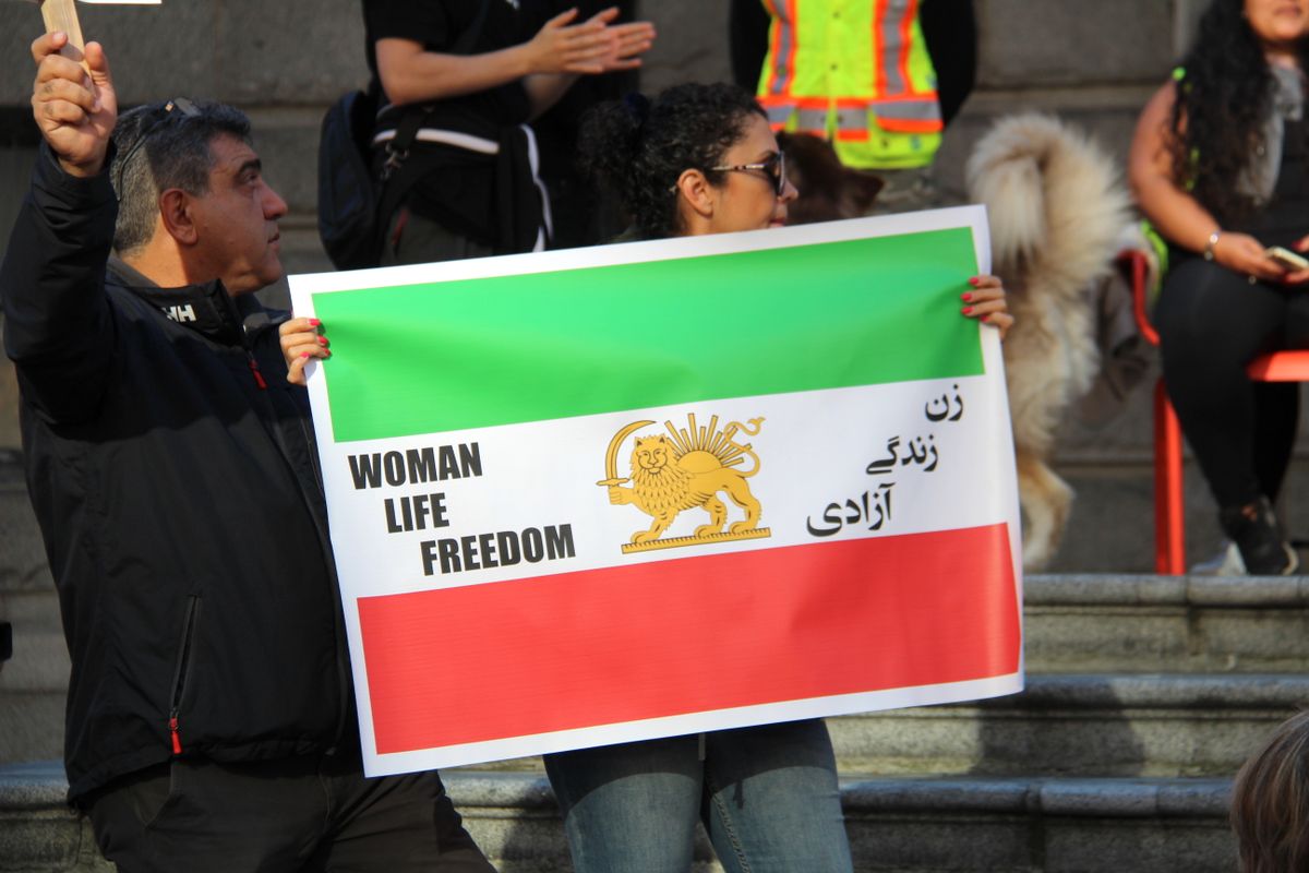 Cyberattacks Hit Water Systems in 7 States, Exposing a Dangerous Failure America Was Warned About 2 People holding signs for the Woman Life Freedom protest in Vancouver, Canada.