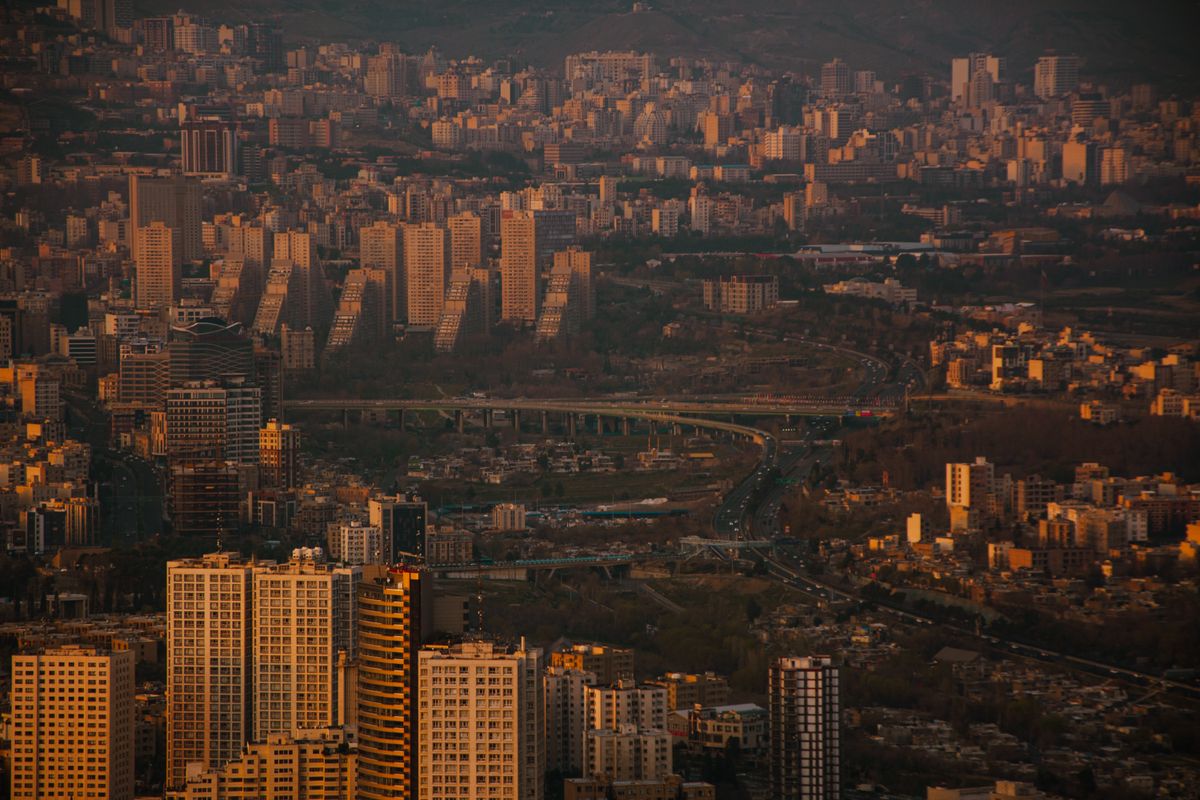 Stunning panoramic view of Tehran's skyline at dusk, showcasing the city's dense urban environment and architectural diversity.