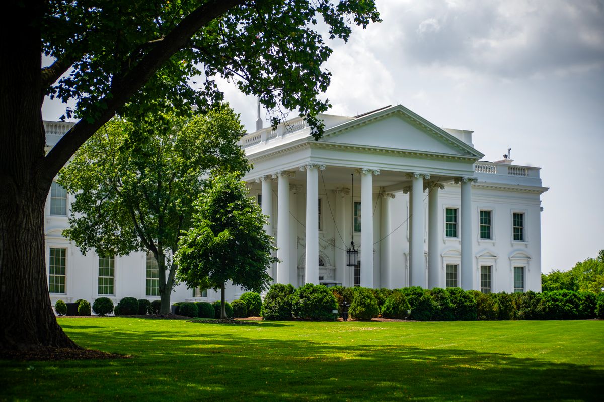 Trump Keeps Jeanine Pirro as $14.6 Million Reflecting Pool Failure Spirals Into a Federal Blame Game. 2 The White House framed by trees and greenery, in Washington, D.C., under a bright sky.