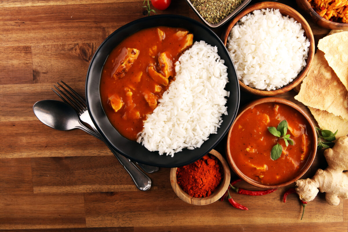 Chicken tikka masala spicy curry meat food in pot with rice and naan bread. indian food with chicken and curry