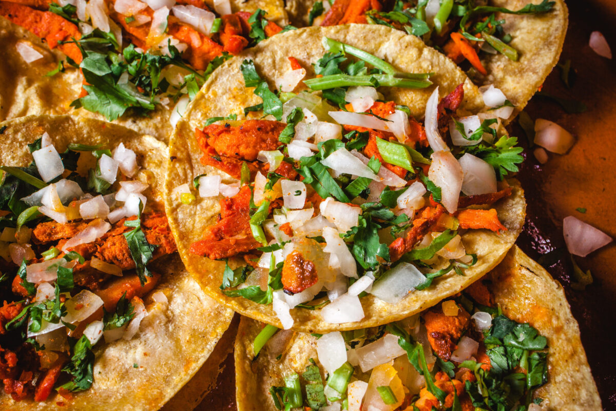 Mexican tacos al pastor, tortillas with pork and vegetables in Mexico City