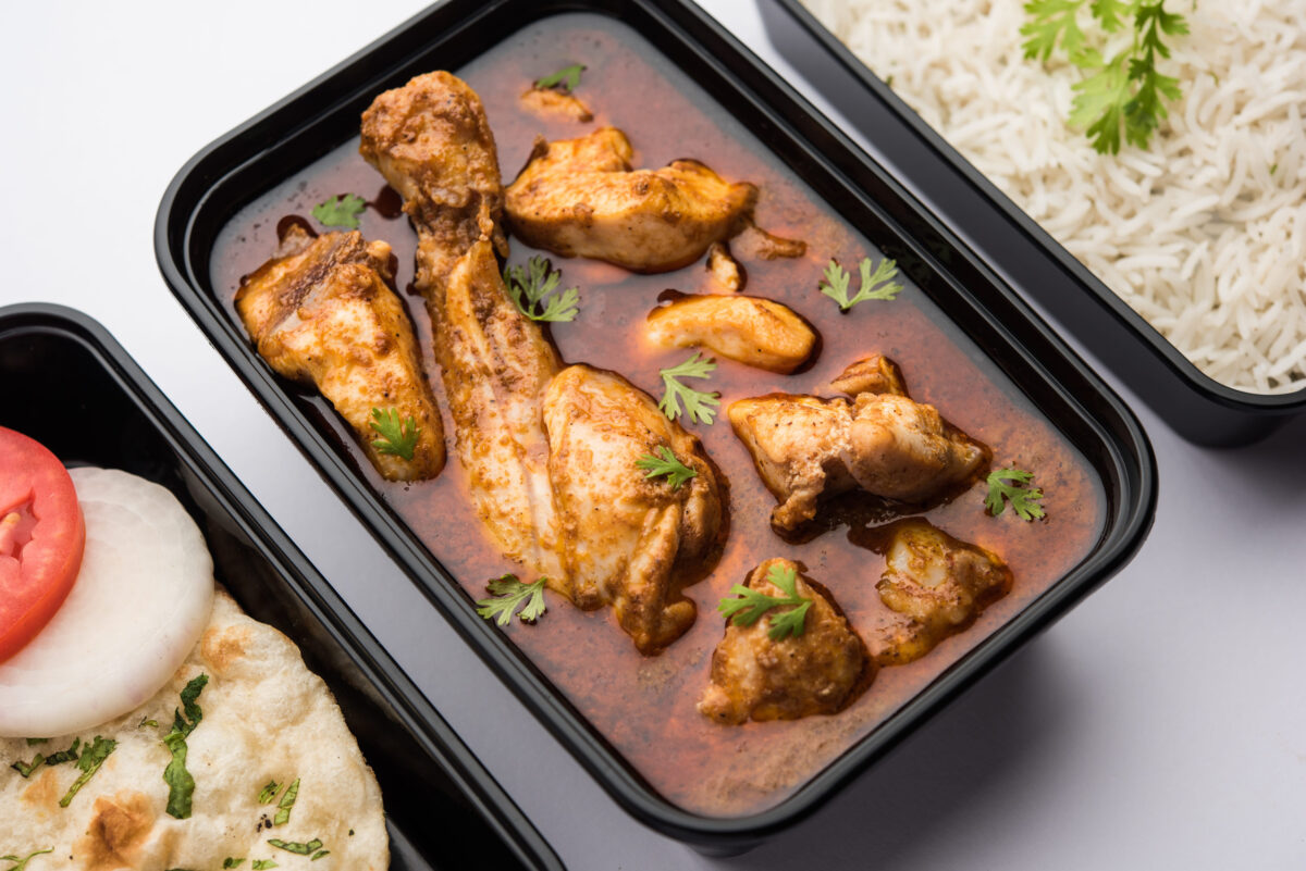 Indian Red Chicken curry packed for home delivery in plastic container