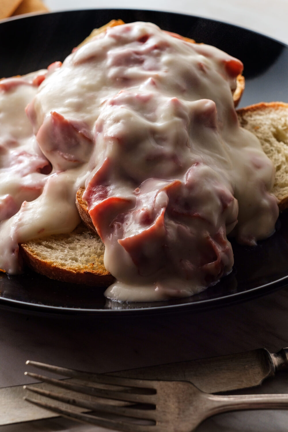 12 Vintage Foods That Time Forgot—But Grandma Didn’t 1 Creamed and chipped beef on sliced toast on marble kitchen table also known as S.O.S.