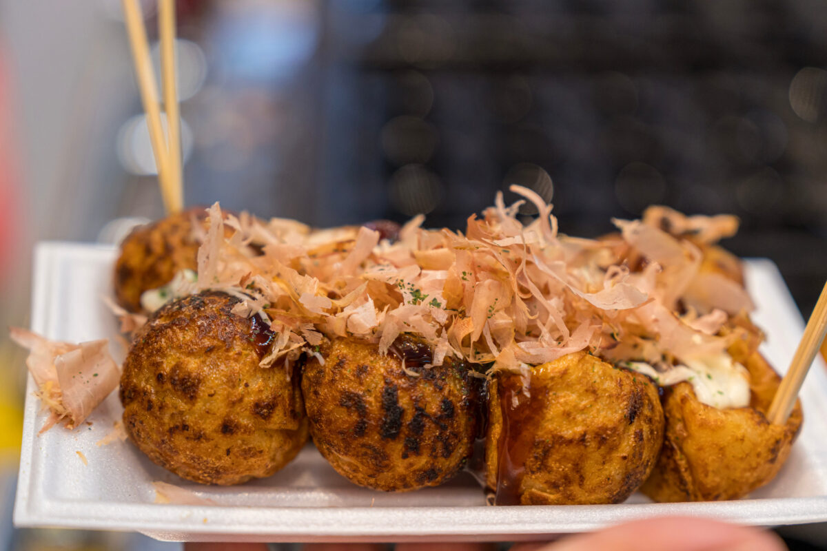 Ball shaped fried octopus balls, Takoyaki. Japanese octopus balls with dried bonito and mayonnaise.