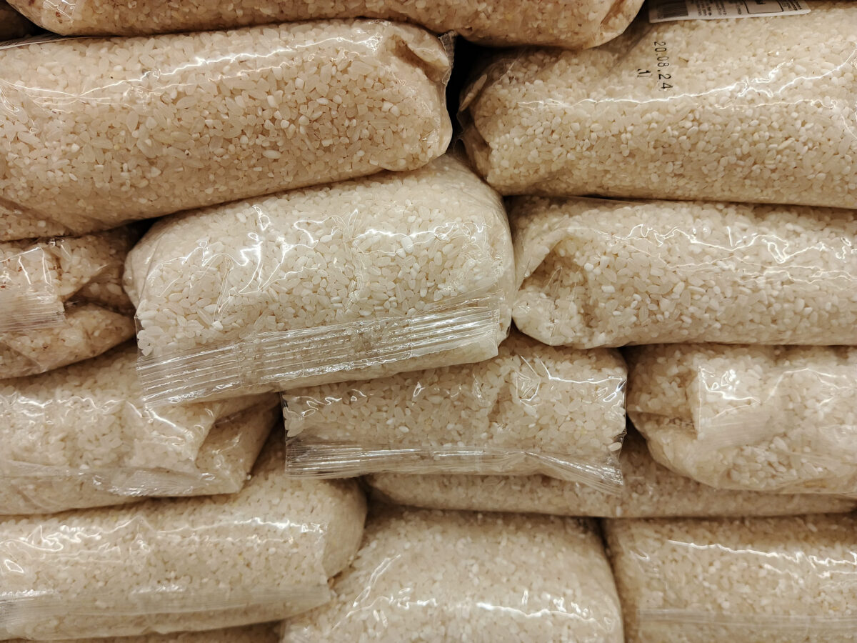 Sesame seeds in plastic bag on shelf in supermarket, closeup