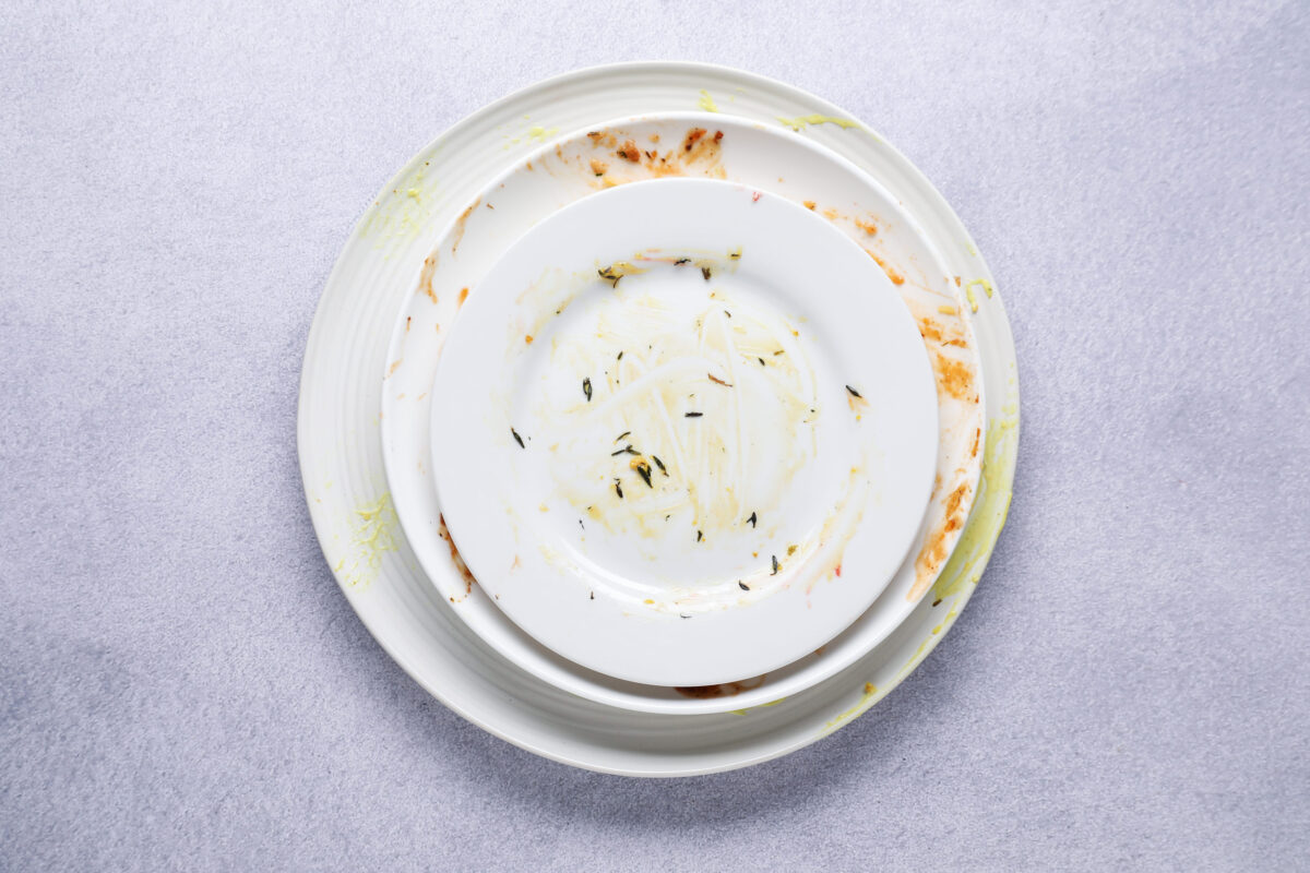 Parents Have Followed These Five Food Rules for Years. It May Be Time to Rethink Them 1 Stack of dirty plates on grey textured table, top view