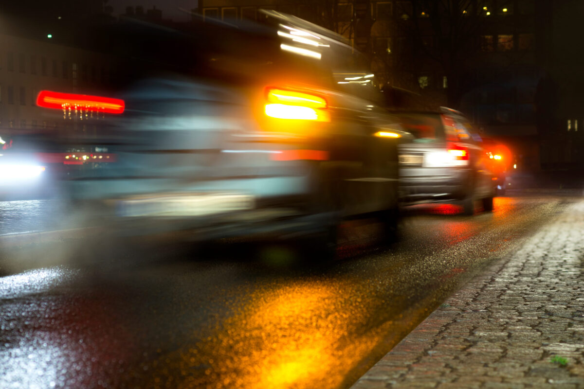 Busy traffic with blurred motion in wet autumn evening