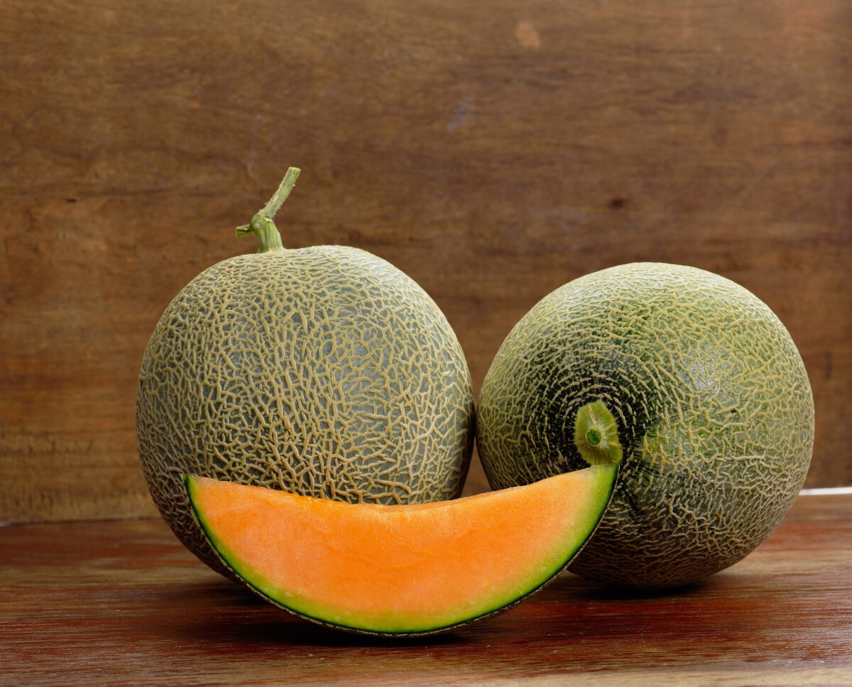 Fresh melon on wooden background.