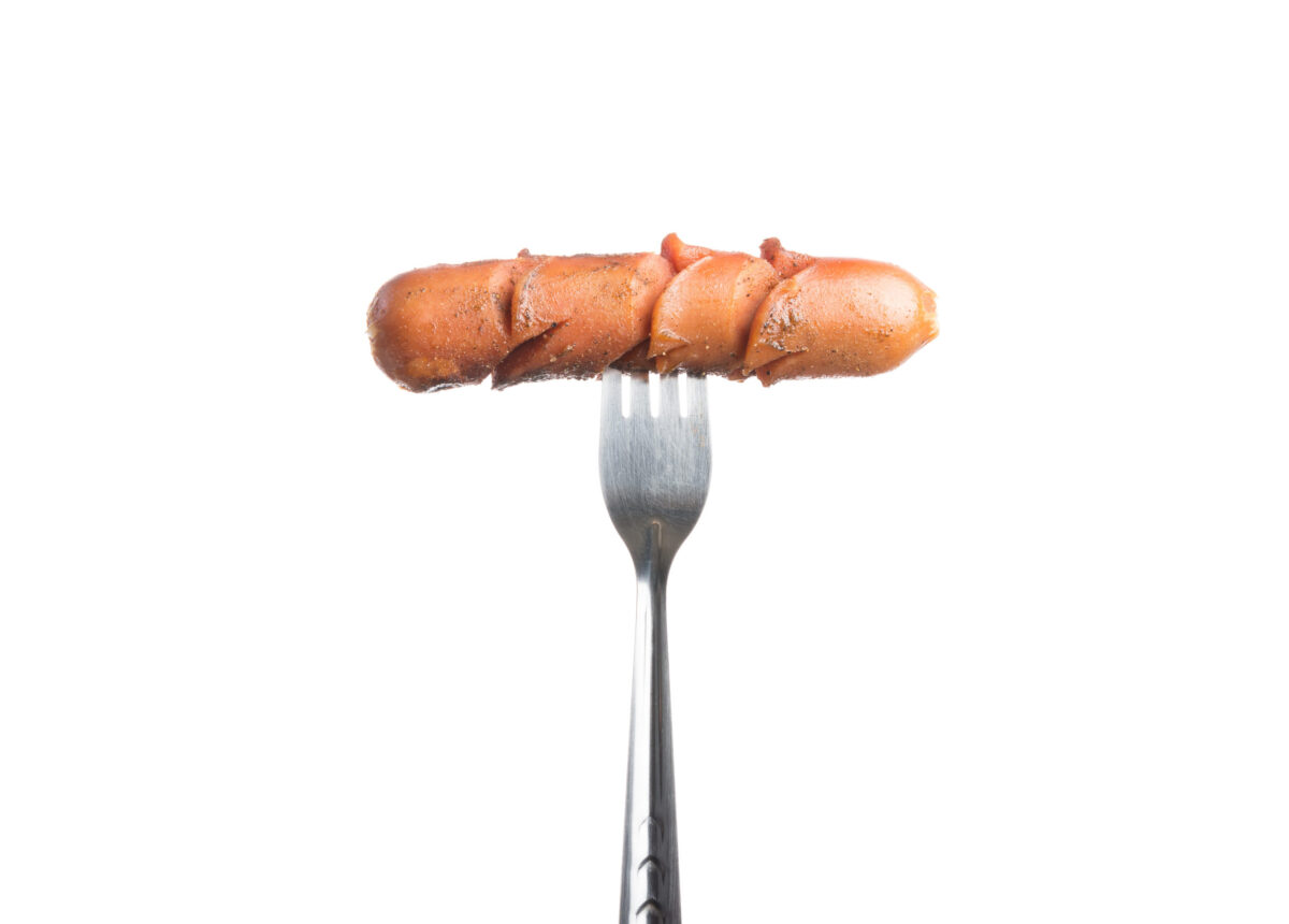 Grilled Sausage on fork isolated on over white background