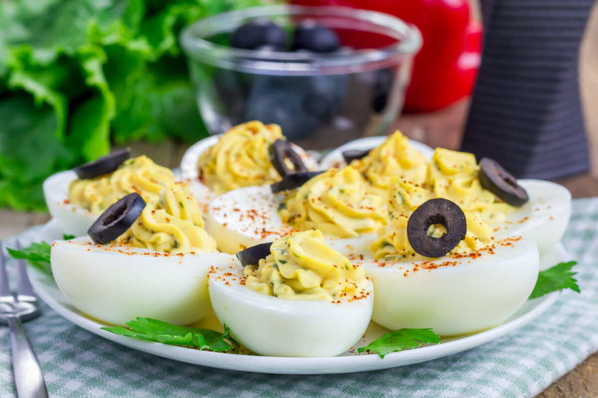 Spicy deviled eggs garnished with olives