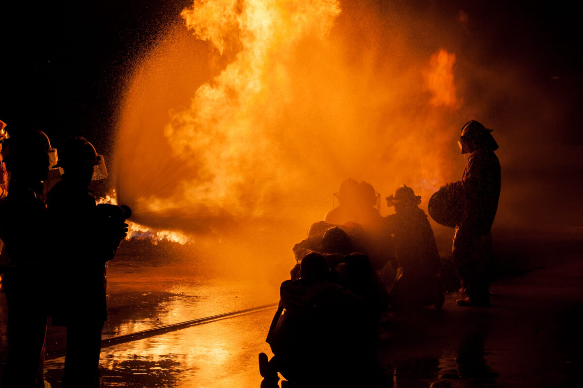 Bridgewater Family Escapes Roger Avenue House Fire as Neighbors Step In 2 Silhouette of Firemen fighting a raging fire with huge flames of burning timber