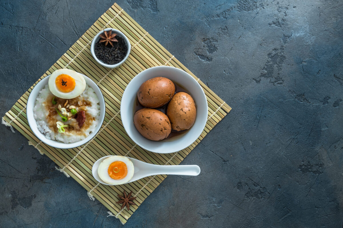 Chinese breakfast with rice porrige and tea eggs, place for text.