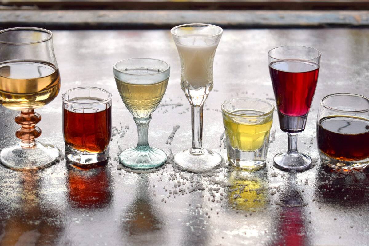 Selection of alcoholic drinks. Set of wine, brandy, liqueur, tincture, cognac, whiskey in glasses. Large variety of alcohol and spirits for making cocktails and drink. Copy space for text.