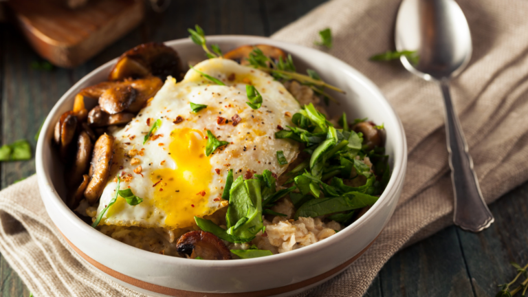 A deliciously crafted bowl of savory goodness, featuring creamy scrambled eggs perched atop a bed of wholesome grains and garnished with vibrant greens. This meal is a perfect fusion of flavors, promising a hearty start to the day or a nutritious midday treat.
