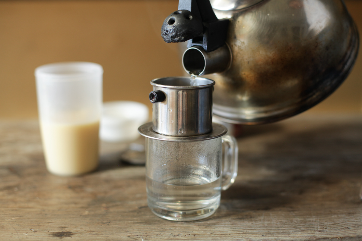 Pouring hot water into filter for Vietnamese Coffee