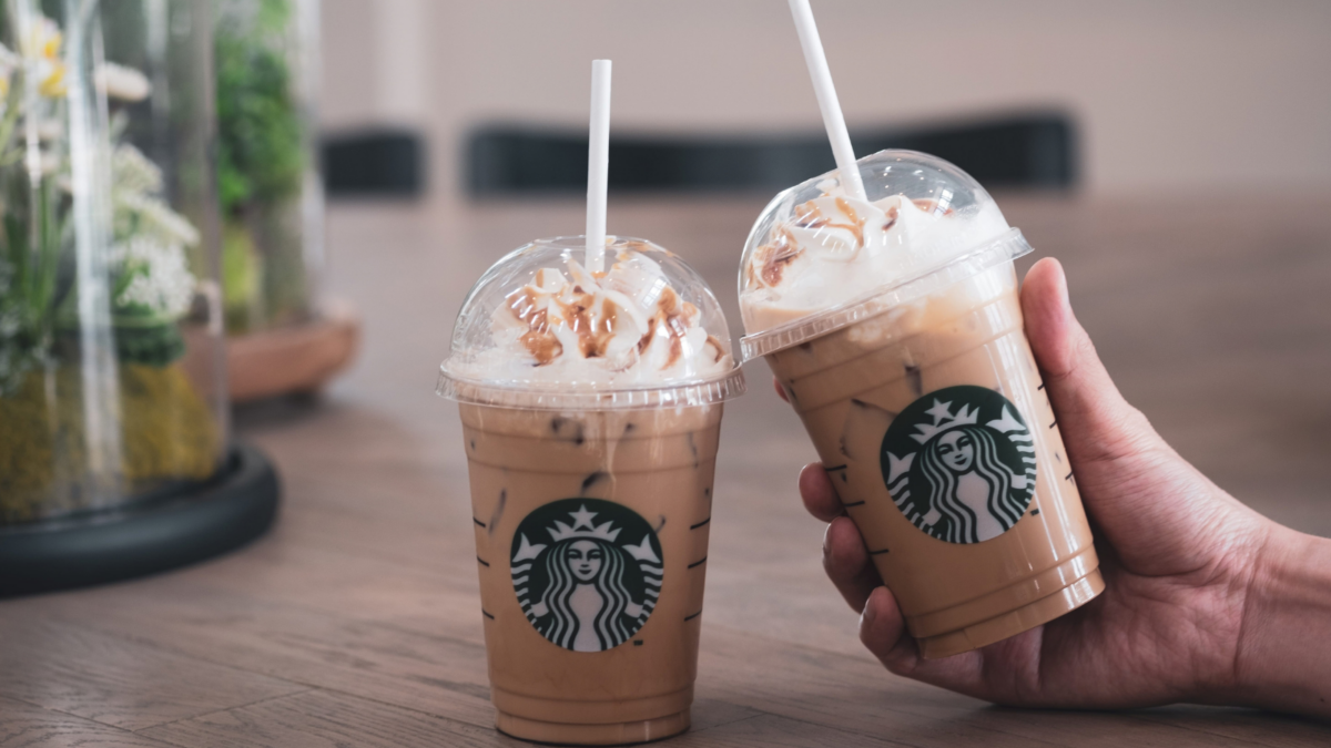Two cup of Starbucks iced coffee with whipped cream in Starbucks coffee shop