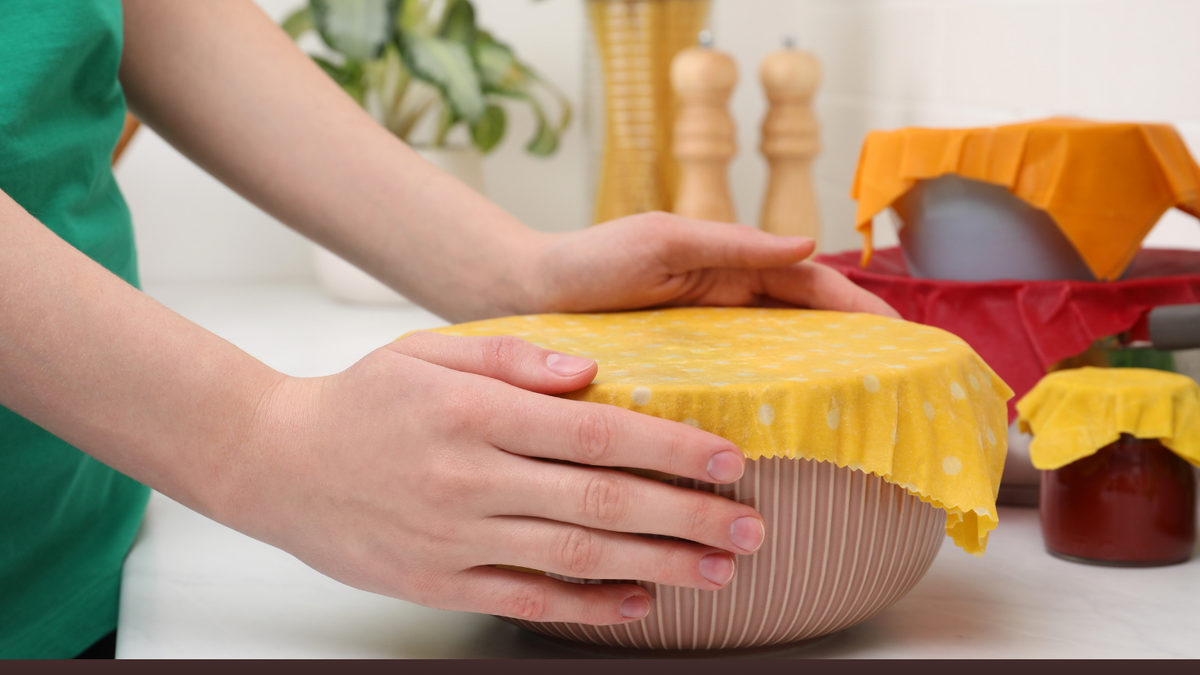 From Dough to Fresh Bread: The Surprising Kitchen Uses for Beeswax Bags 1 Woman holding bowl covered with beeswax food wrap at white table