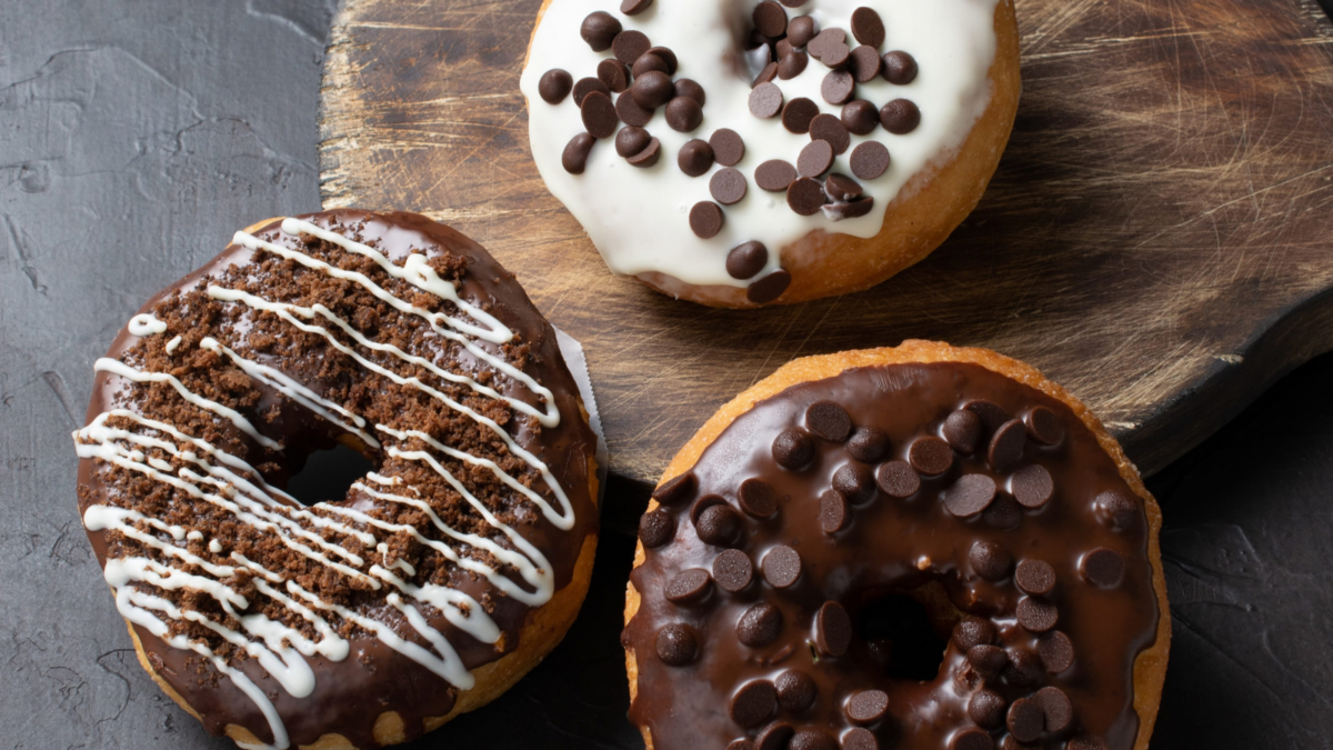 Indulge in a delightful trio of chocolate donuts, each uniquely topped with rich chocolate chips and creamy frosting. Perfect for satisfying any sweet tooth, these treats bring a touch of joy to every bite and are ideal for sharing with friends over coffee or enjoying during a cozy night in.